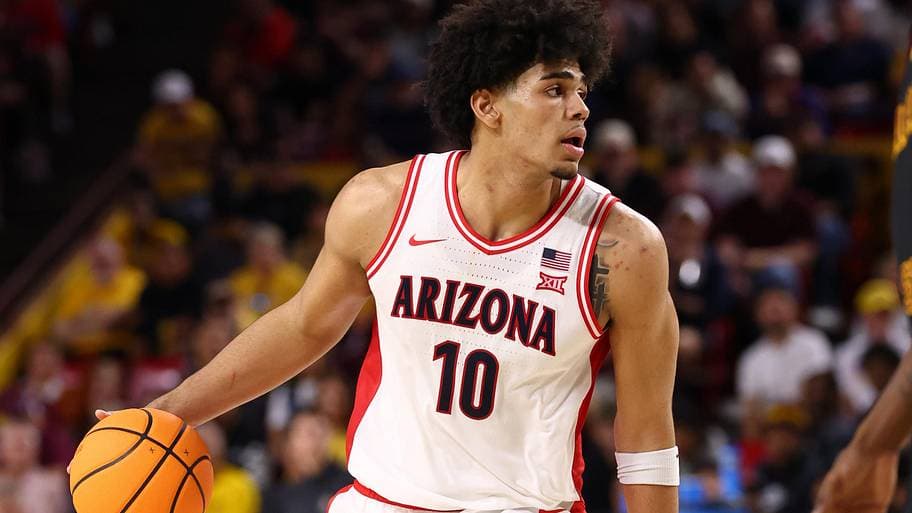 The Suns' recent first-round pick pictured in his Arizona Wildcats uniform, handling the ball during a college game.