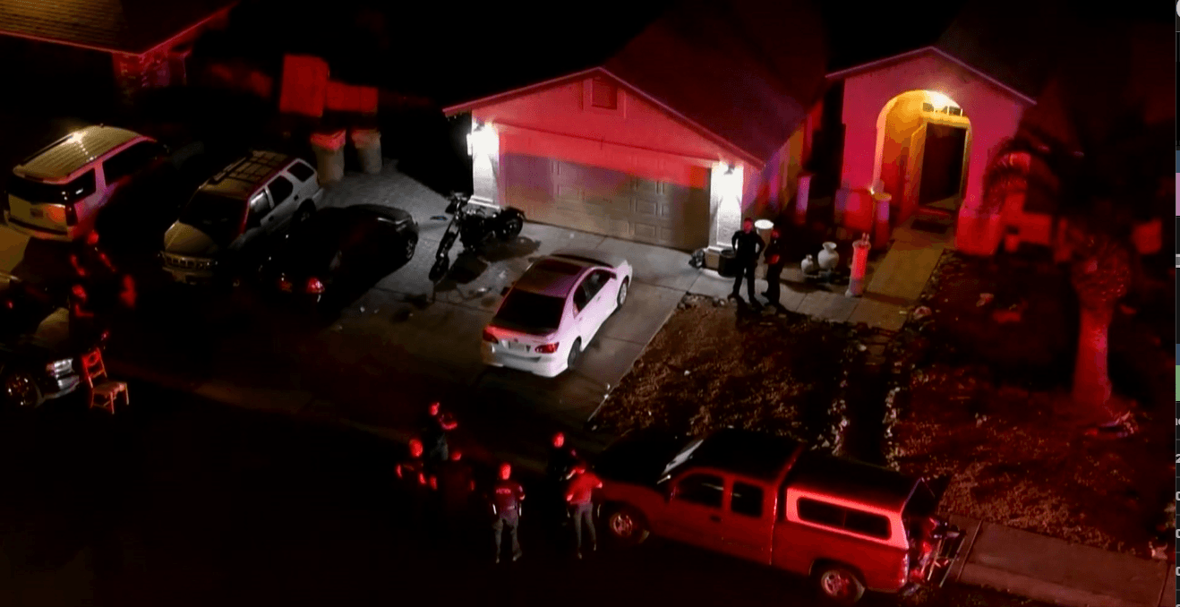 Officers and investigators gather in a Glendale driveway as emergency lights illuminate the neighborhood after an overnight shooting that left three people wounded.