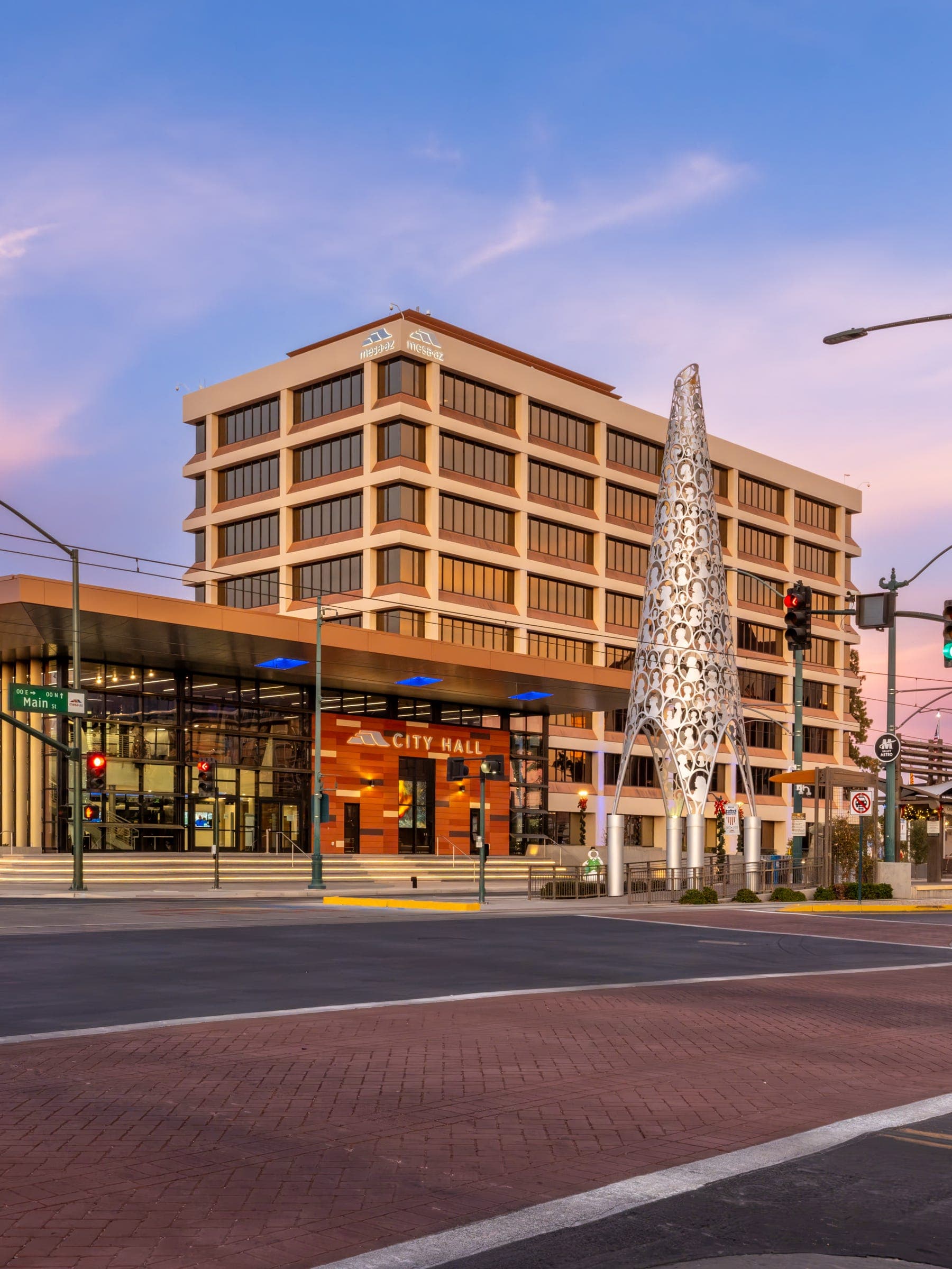 Downtown Mesa City Hall and public sculpture at dusk — a focal point in District 4, which will elect a new City Council member in the July 21 primary.