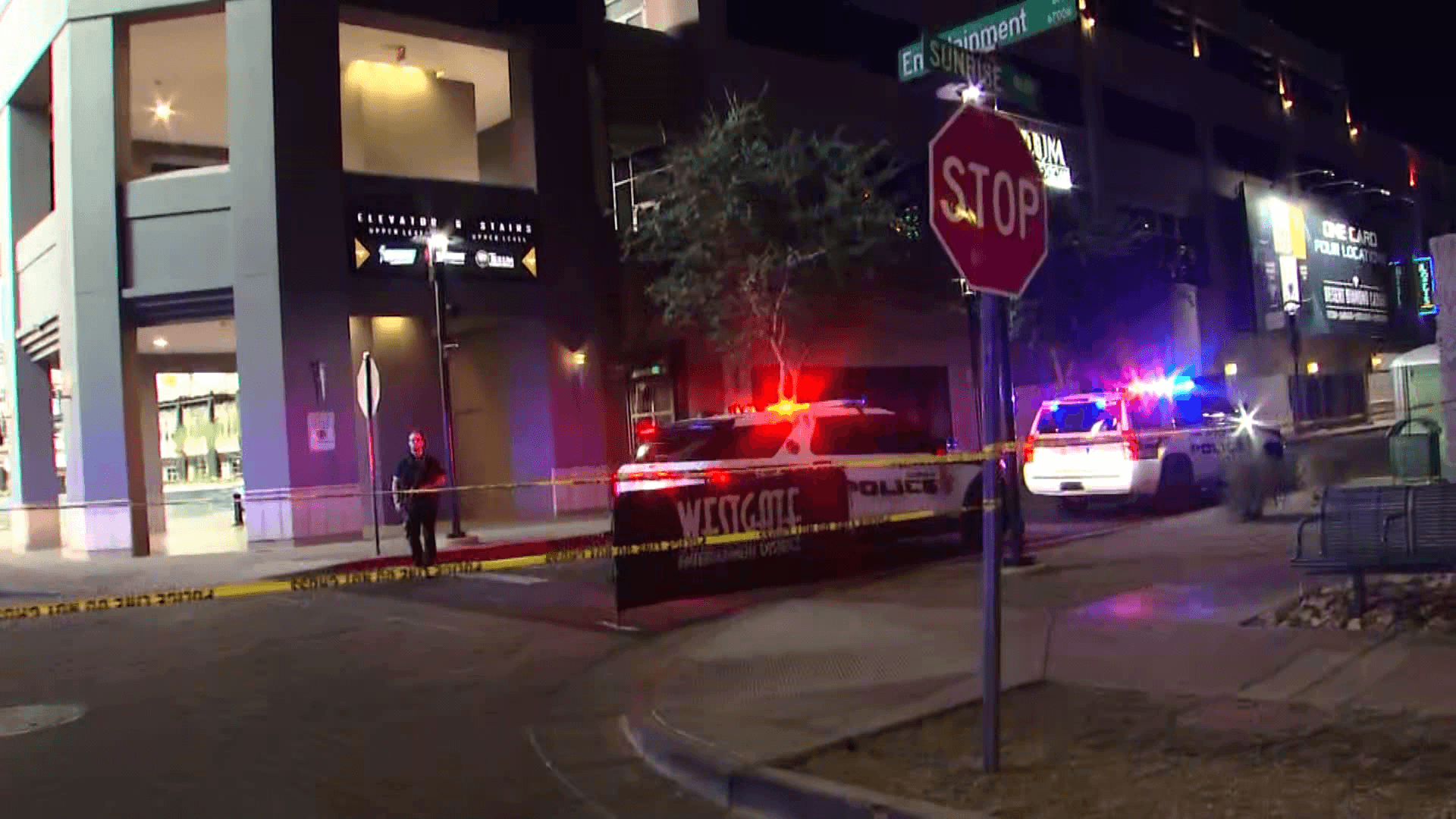 Police vehicles and yellow crime‑scene tape block a Glendale street near an entertainment area while officers investigate the shooting that sent three people to the hospital.