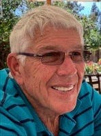 Portrait used on the obituary page titled "Dennis Wise" — an older man with white hair and sunglasses smiling outdoors.