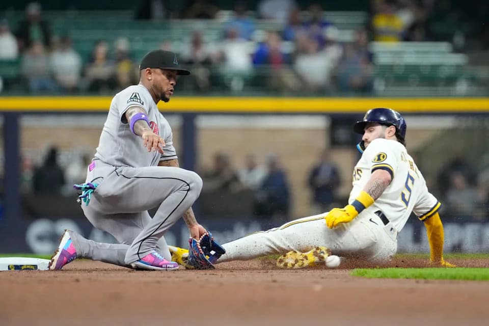 Brewers baserunner slides into second as a Diamondbacks infielder attempts the tag during Friday’s extra-innings matchup in Phoenix.