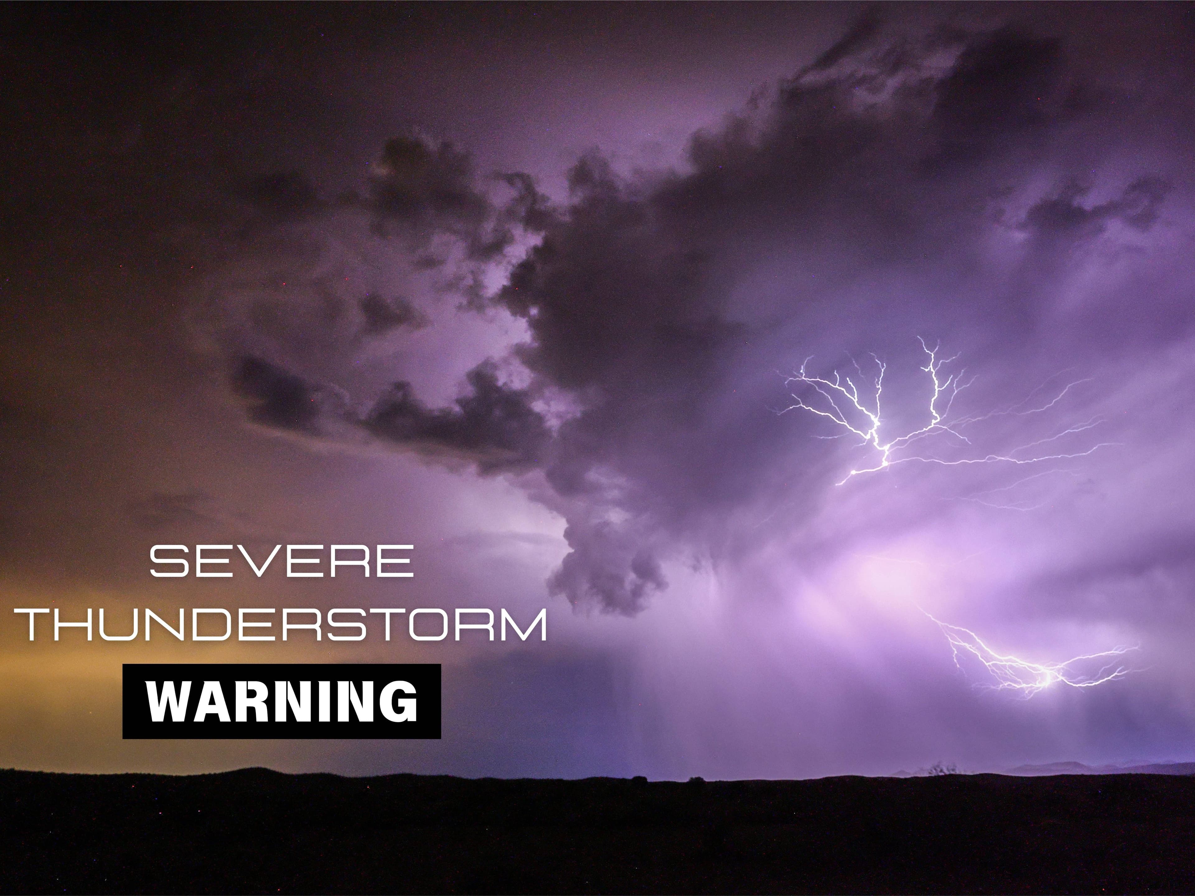 Lightning illuminates towering storm clouds as a severe thunderstorm warning graphic — illustrating the line of storms moving through the Phoenix area that prompted warnings for wind gusts up to 80 mph and reports of hail.