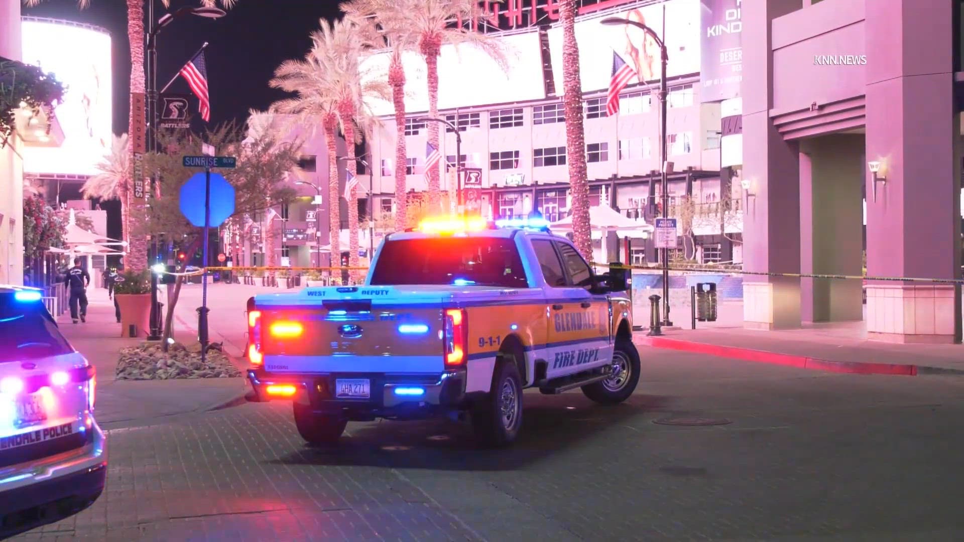 Emergency vehicles and police tape cordon off a downtown street as officers investigate a stabbing; police say a suspect remains at large.