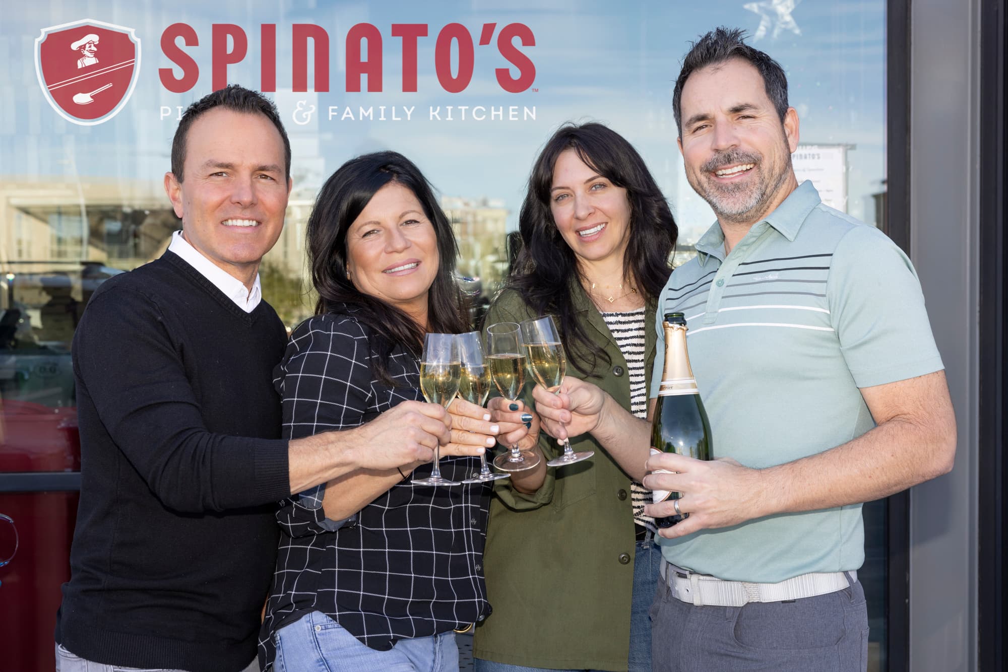 Spinato’s team members toast outside a restaurant location as the pizzeria announces plans to open a new Goodyear location and relocate its north Phoenix site.