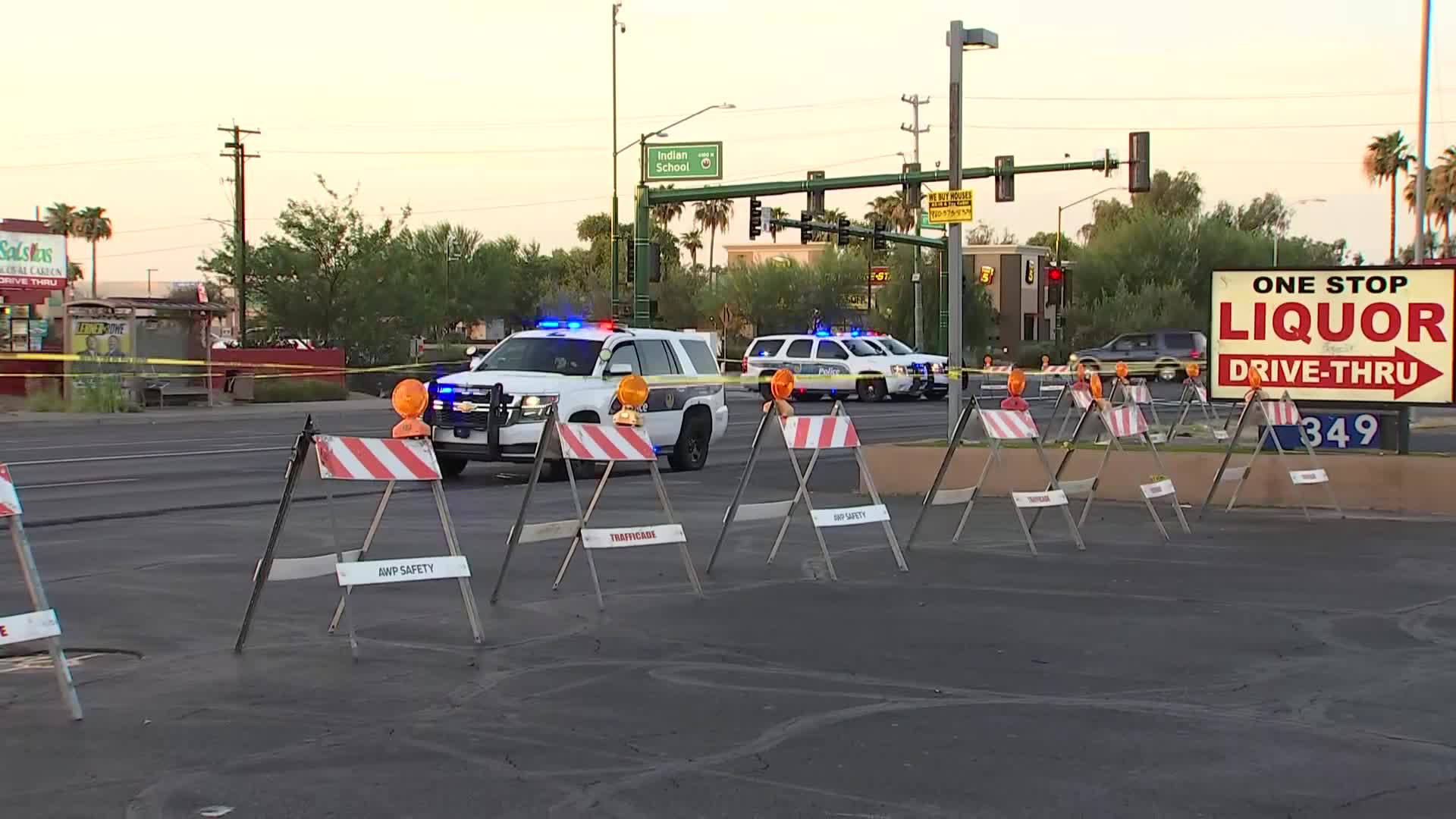 Police block the intersection of Indian School Road and 67th Avenue in Maryvale early Saturday after a pedestrian was struck, with patrol vehicles, barricades and crime‑scene tape visible.