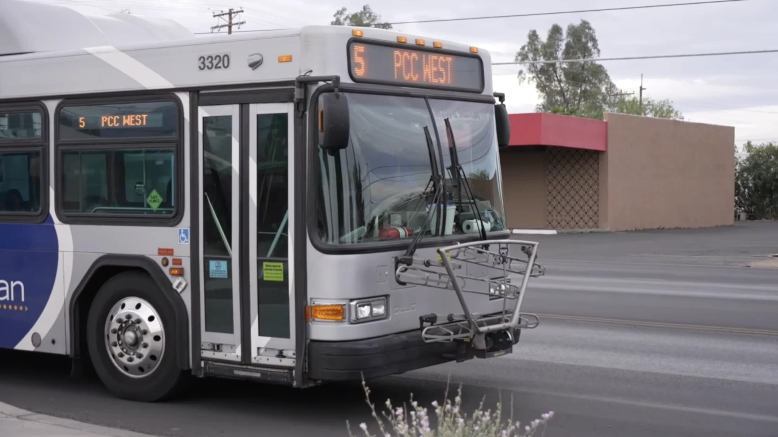 A City of Tucson Sun Tran bus (Route 5, “PCC West”) parked on a neighborhood street; city leaders are asking residents to help shape the Transit Safety and Security Action Plan.