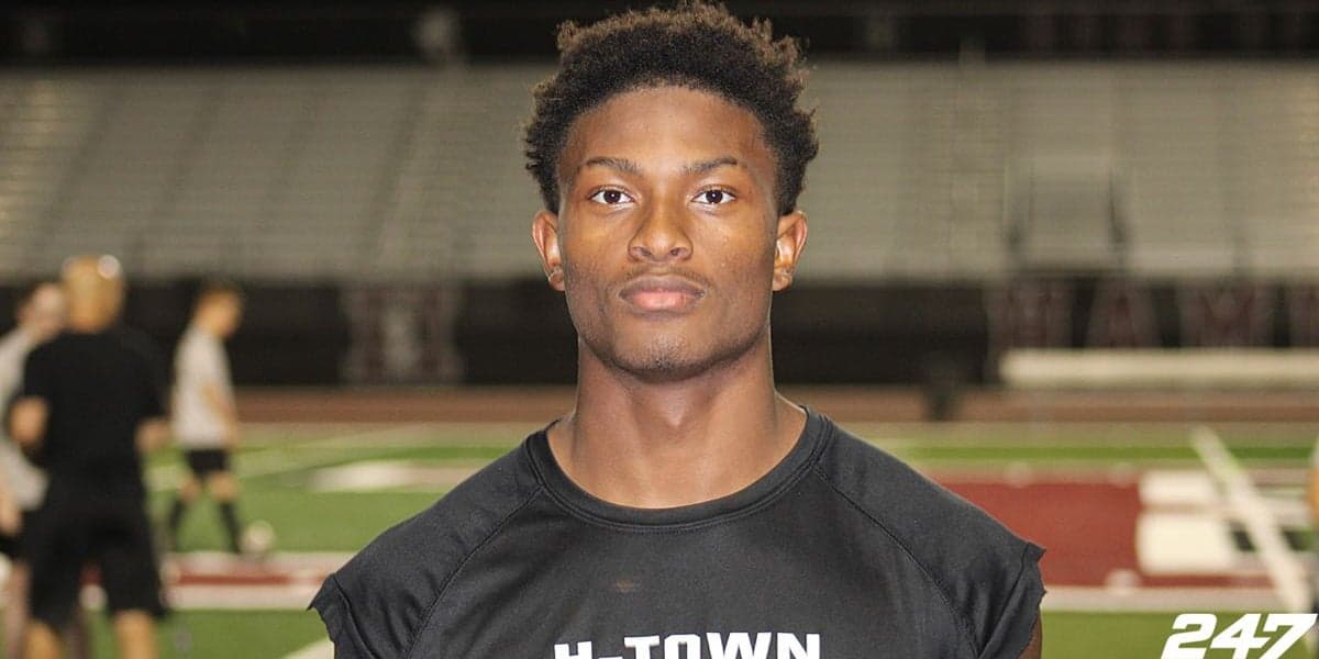 An Arizona high-school defensive back photographed on a practice field; the player recently took an unofficial visit to Wisconsin as part of the recruiting process.