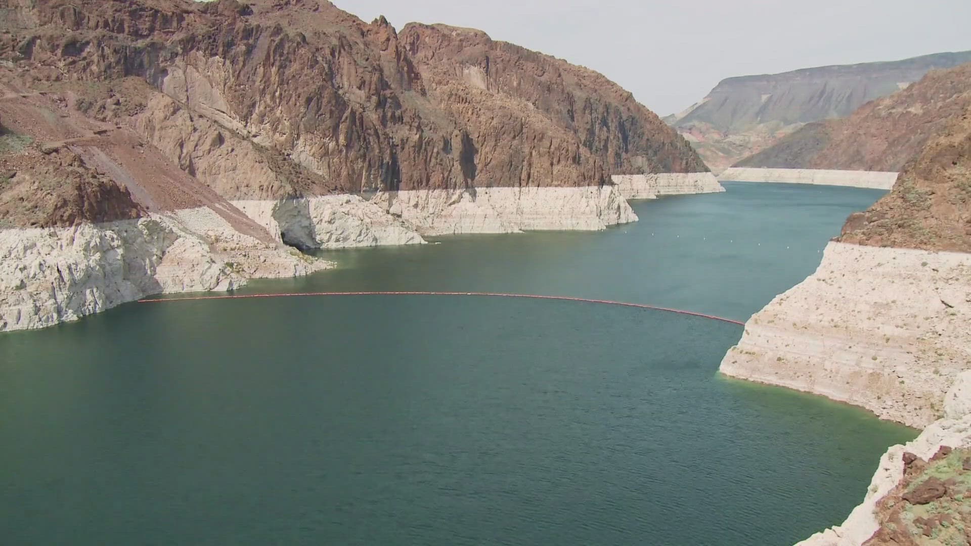 A Colorado River reservoir with a visible 'bathtub ring' from low water levels — Phoenix has retained law firms as it considers legal options to fight proposed federal cuts to river allocations.