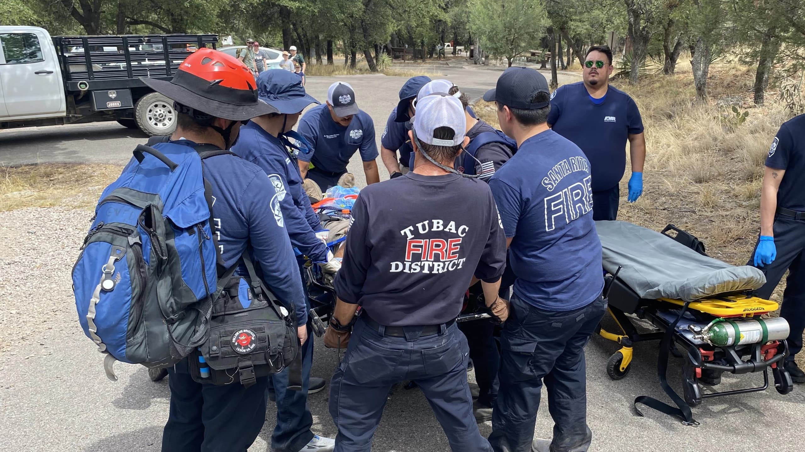 Rescue crews from Tubac Fire District and Santa Rita Fire assist a hiker onto a stretcher after a medical emergency in Madera Canyon.