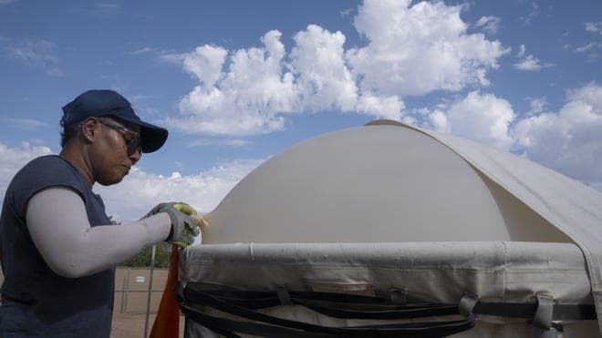A technician secures a weather balloon to the launch rig at ASU ahead of ascent as part of research operations during the 2026 monsoon season.