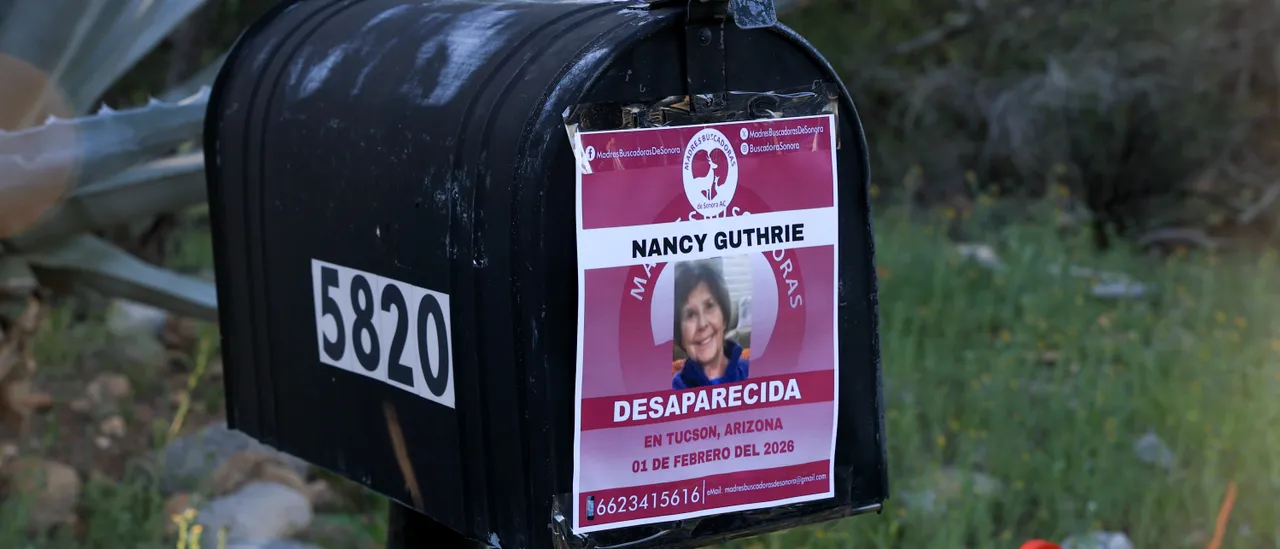 A missing-person flyer for the woman at the center of the Tucson disappearance taped to a rural mailbox as investigators continue the search.