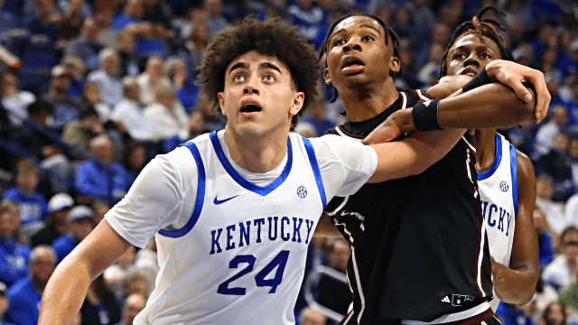 Kentucky players battle for position under the basket during a home contest, illustrating the Wildcats' on-court play ahead of the newly announced seven-game nonconference home slate.