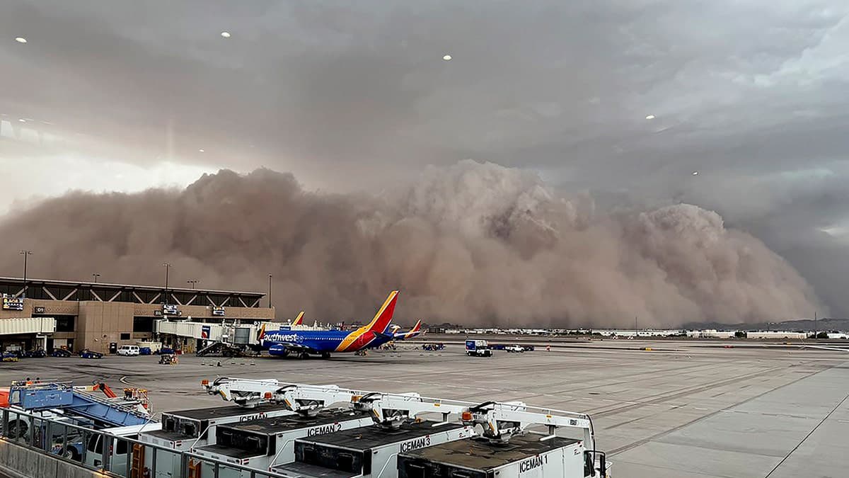 A massive haboob dust front barrels toward a Phoenix-area airport in Scottsdale as grounded aircraft sit at the gate during one of the back-to-back Category 5 dust storms.