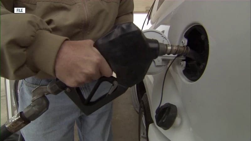 A motorist pumps gas into a vehicle at an Arizona station; state fuel prices fell slightly over the last week while remaining higher than a year ago.