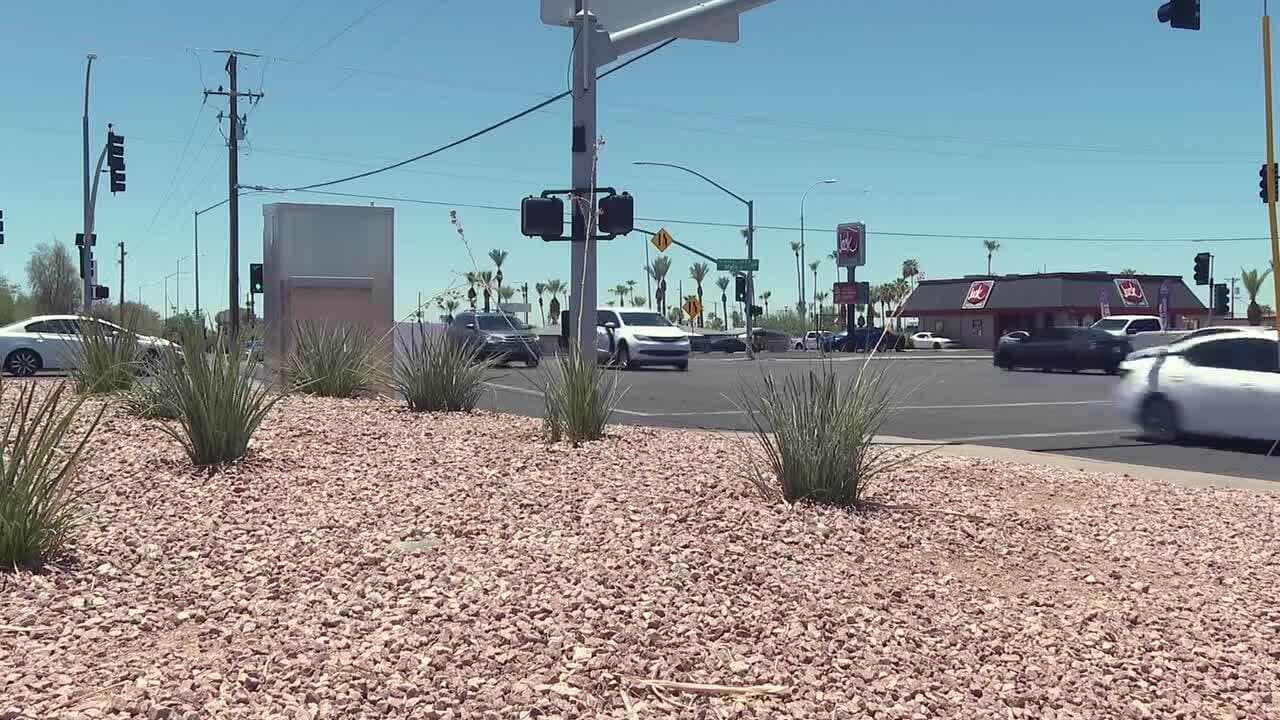 Vehicles and local businesses at an intersection near the proposed Main Street market site in Mesa, illustrating the commercial corridor the restaurant incubator aims to serve.