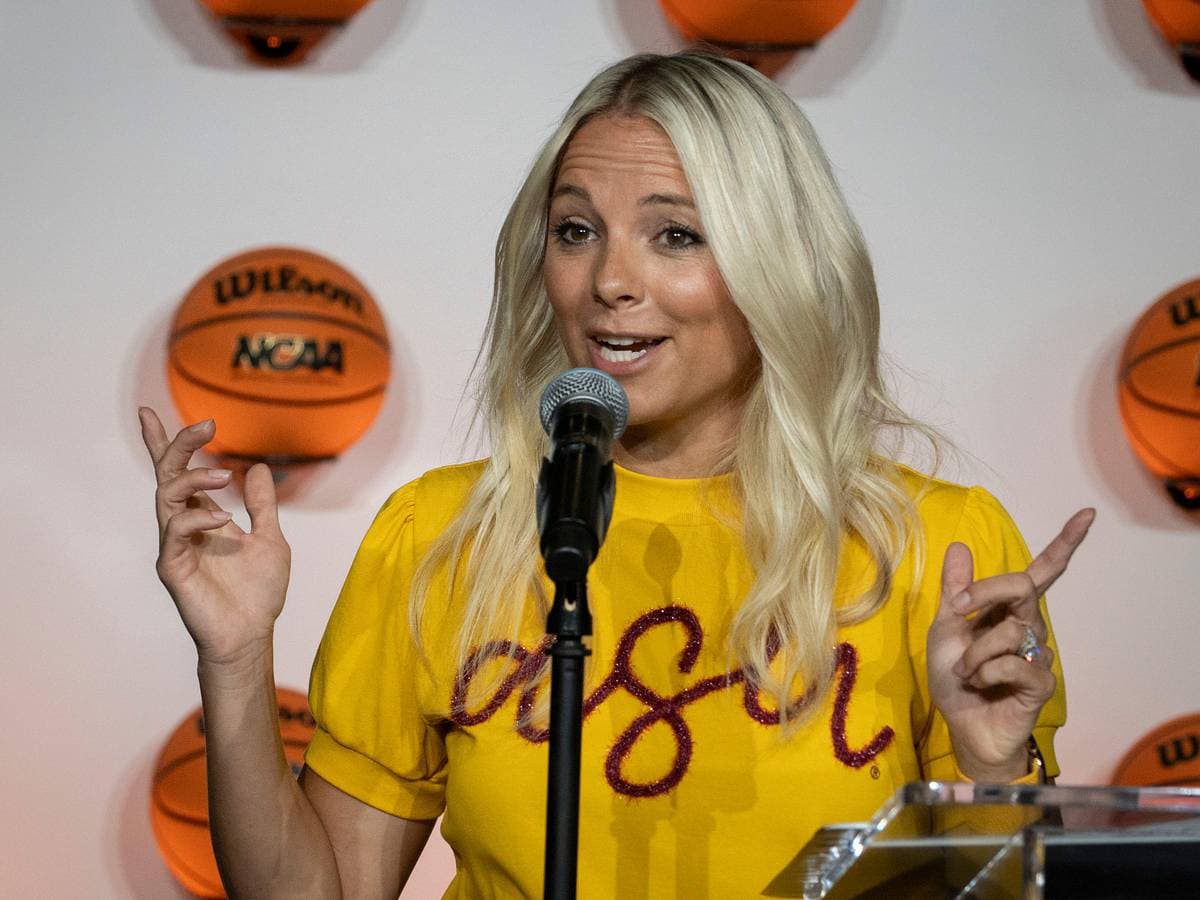 Sun Devil coach speaks at a media event wearing ASU colors, addressing plans to rebuild and refocus the women’s basketball program.