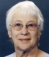 Studio portrait used in the obituary showing the subject (1930–2026) with glasses and a gentle smile, reflecting a longtime teacher remembered by the community.
