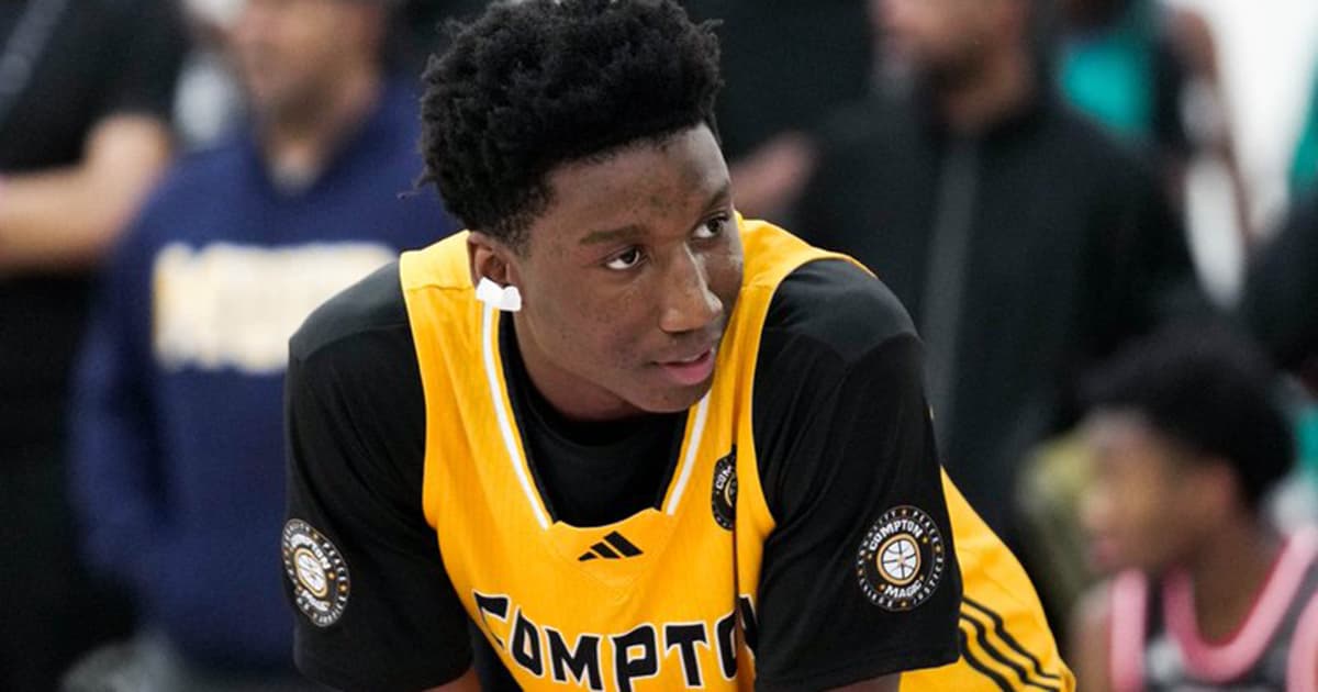 A high-school prospect in a Compton jersey competes at a grassroots showcase — events like this drew hundreds of college coaches, including staff from Louisville.