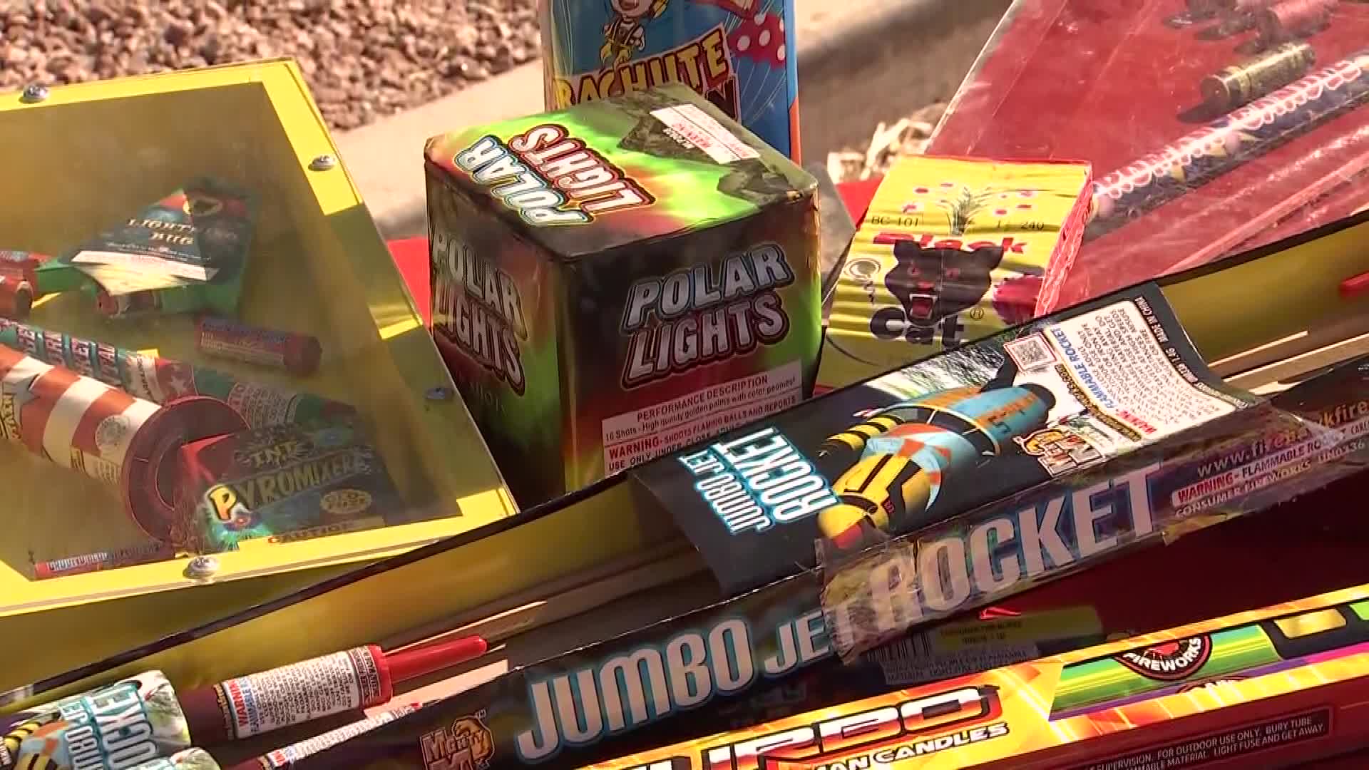 Boxes of consumer fireworks on display at a Valley booth as residents prepare for the Fourth of July; Phoenix officials remind the public about citywide bans and Stage 1 fire restrictions.