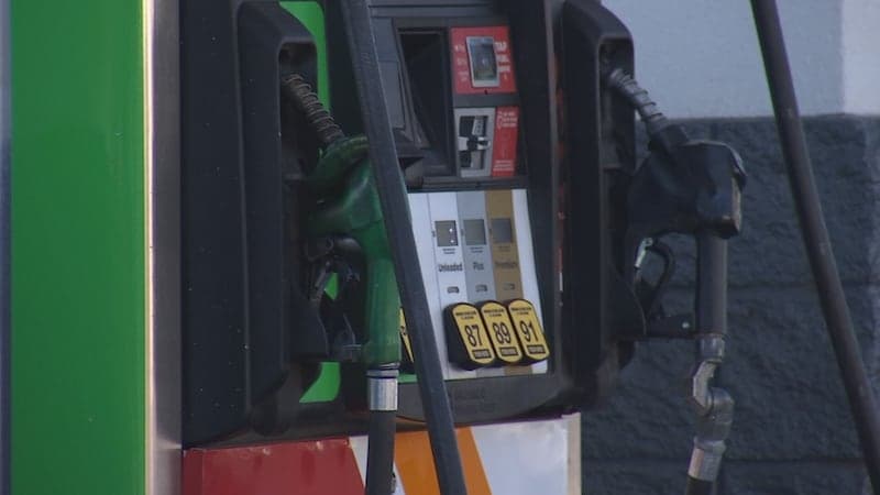 Close-up of gas pump nozzles at an Arizona station; gasoline averaged about $3.95 per gallon this week after a roughly $0.13 weekly decline.