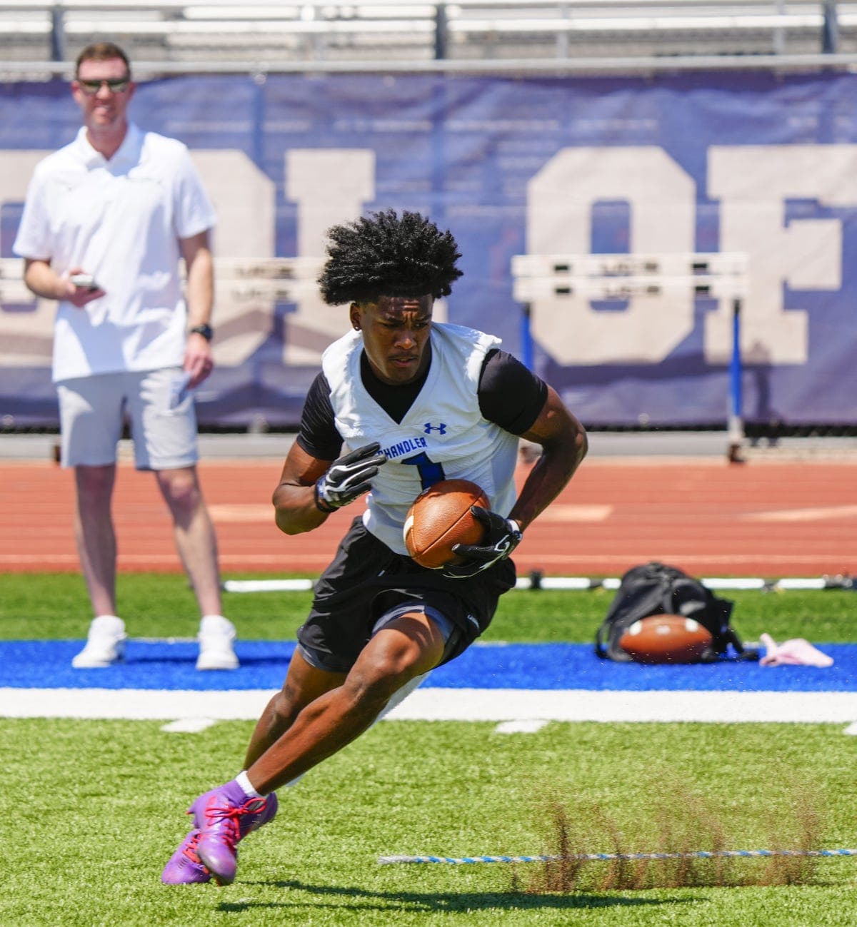 Chandler wide receiver breaks a drill on the field during a summer showcase — one of the prospects highlighted in the 2026 top‑10 receivers vote.