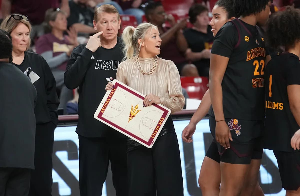 Sun Devil coach directs players from the sideline, holding a clipboard with the ASU logo during a game as part of efforts to reshape ASU women’s basketball.