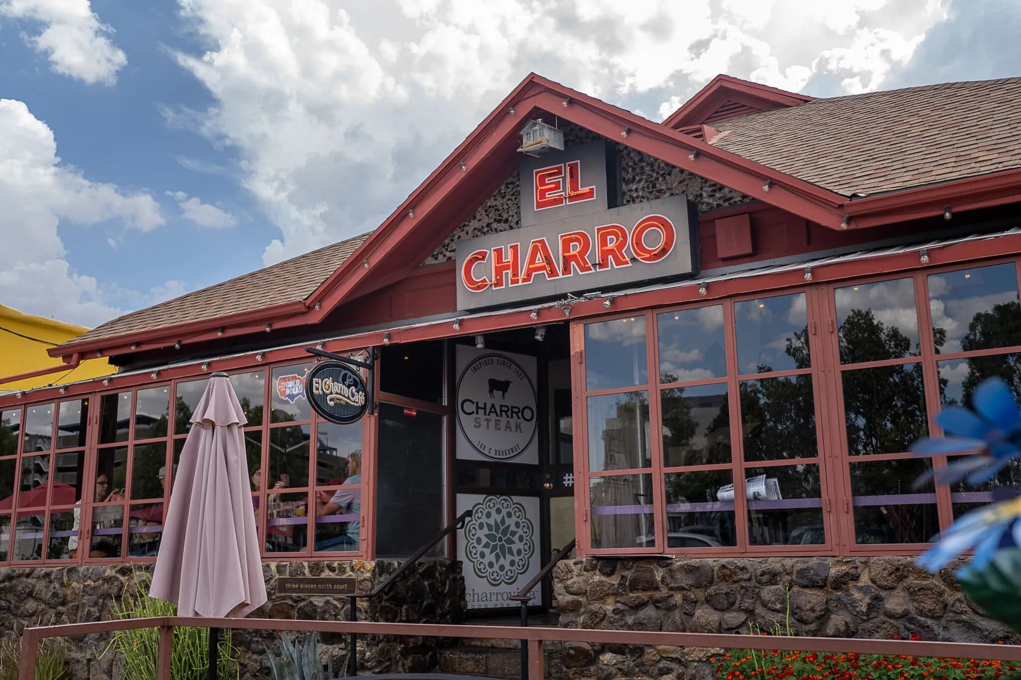 Exterior view of El Charro’s storefront and patio seating, the 103-year-old family-owned Tucson restaurant highlighted in the report on family businesses.