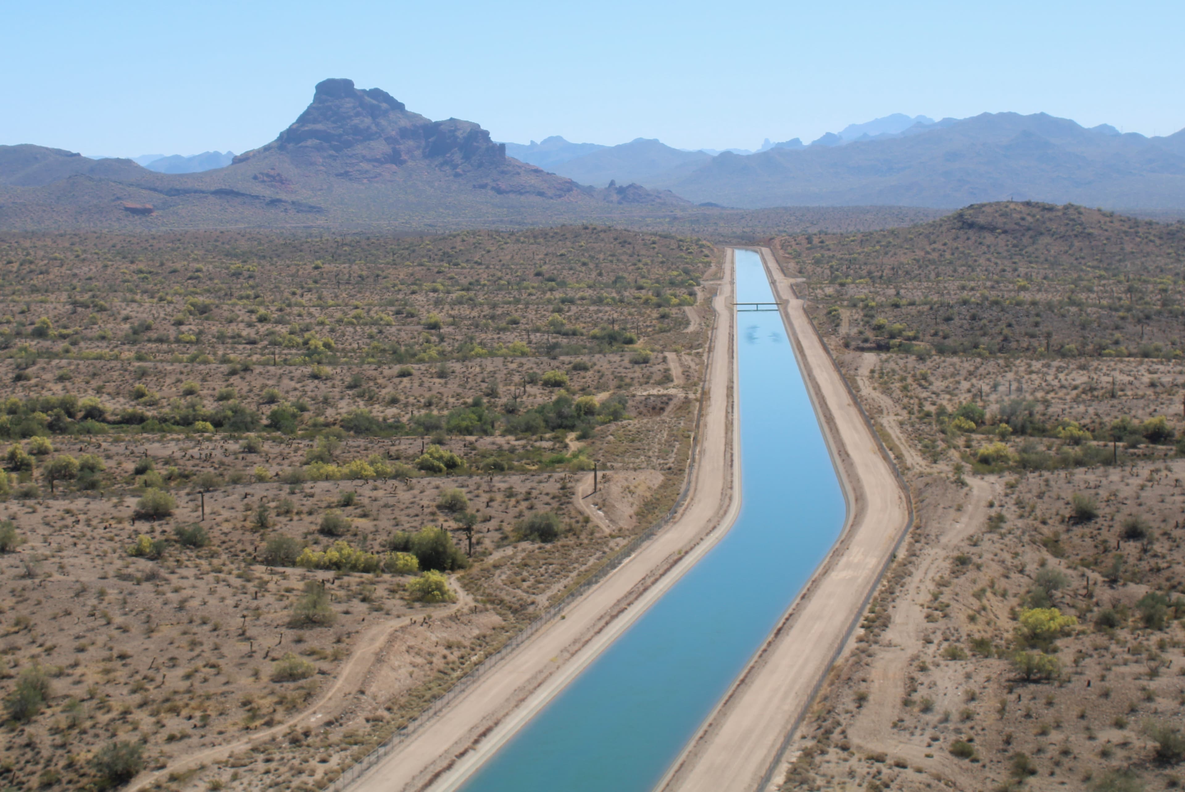 Aerial view of a major canal conveying Colorado River water across desert Arizona — water deliveries like this are central to concerns over supporting new nuclear capacity.