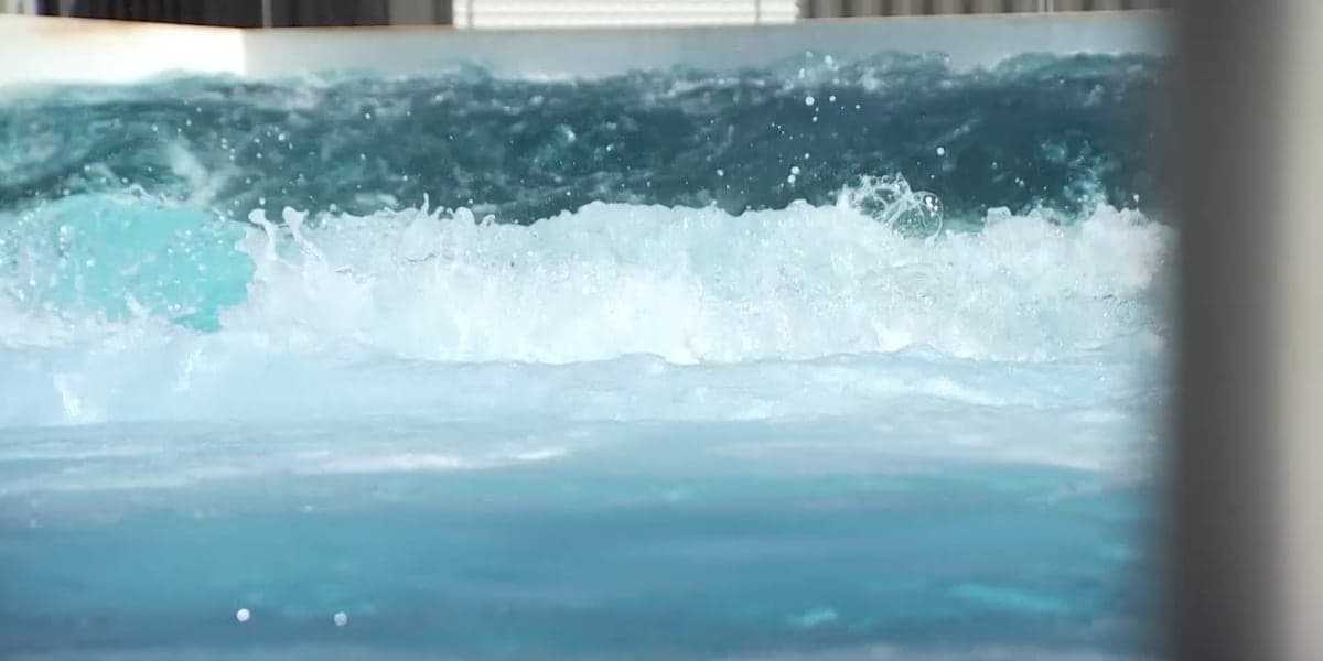 Waves breaking in the pool at a Mesa surf park, where nanobubble technology — similar to systems used at the DC Reflecting Pool — is used to help keep the water clean.