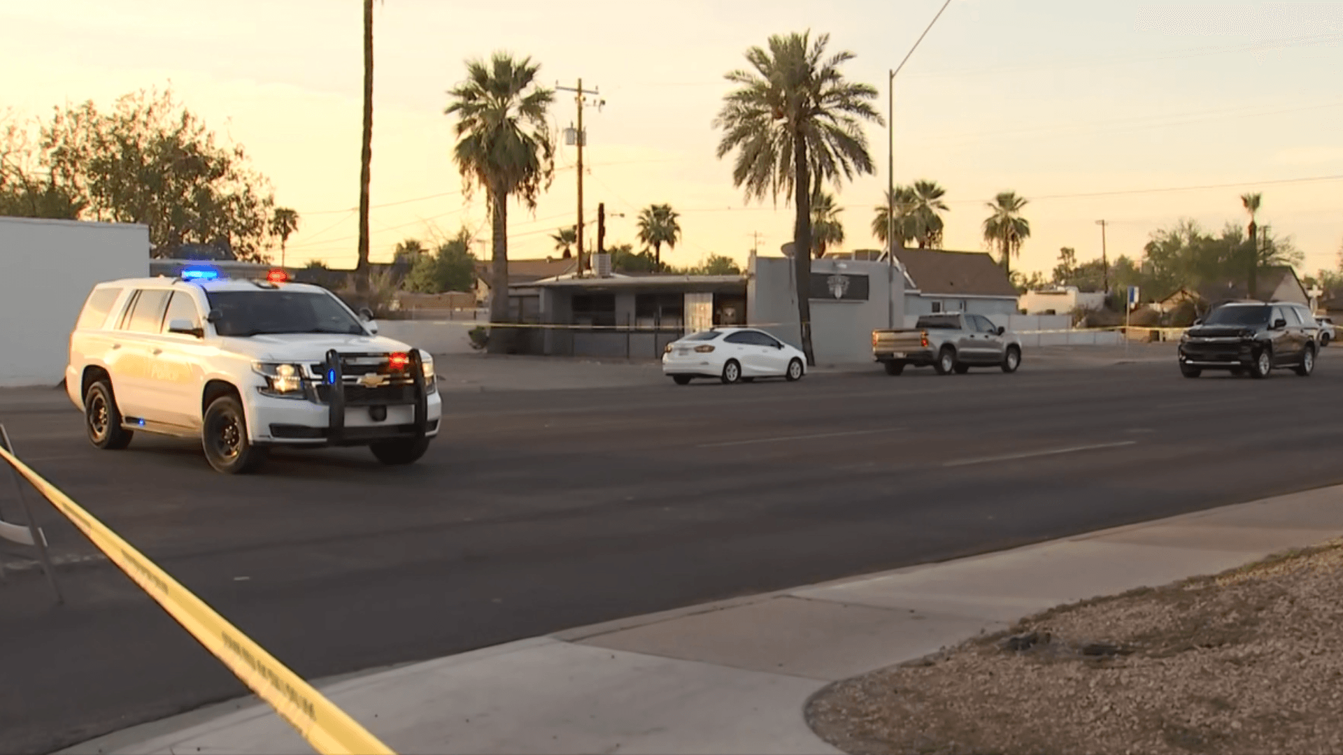 Police block a stretch of road near 16th and Brill in central Phoenix after a pedestrian was struck by an SUV; crime-scene tape and a police SUV are visible.