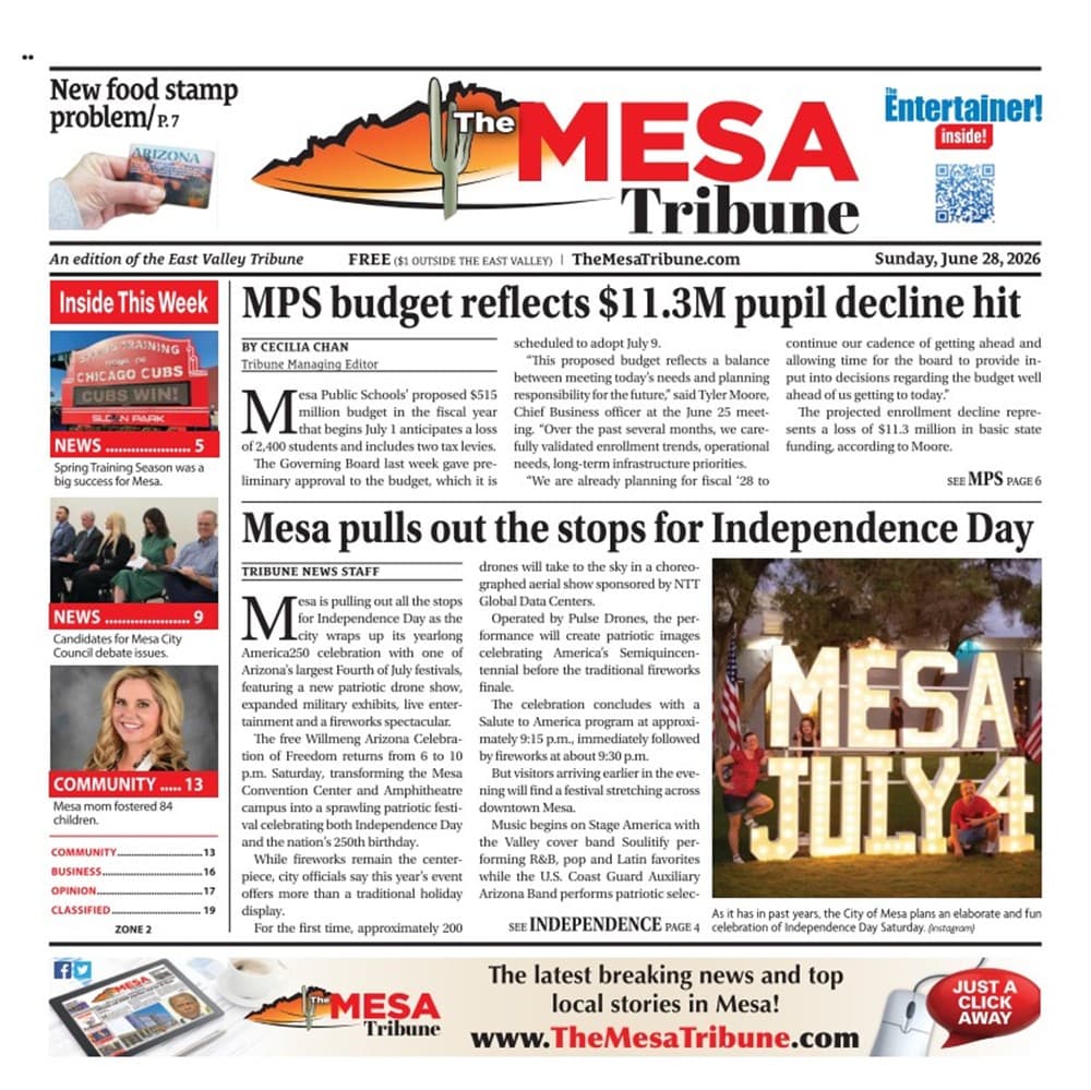 Visitors pose at an illuminated 'MESA JULY 4' sign during the City of Mesa's Independence Day celebration, part of the article's coverage of the holiday festivities.