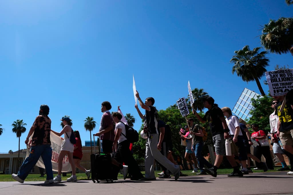 A low-angle view of demonstrators walking with signs and banners beneath palm trees, representing one of the visibility actions and rallies listed in the article’s statewide event guide.