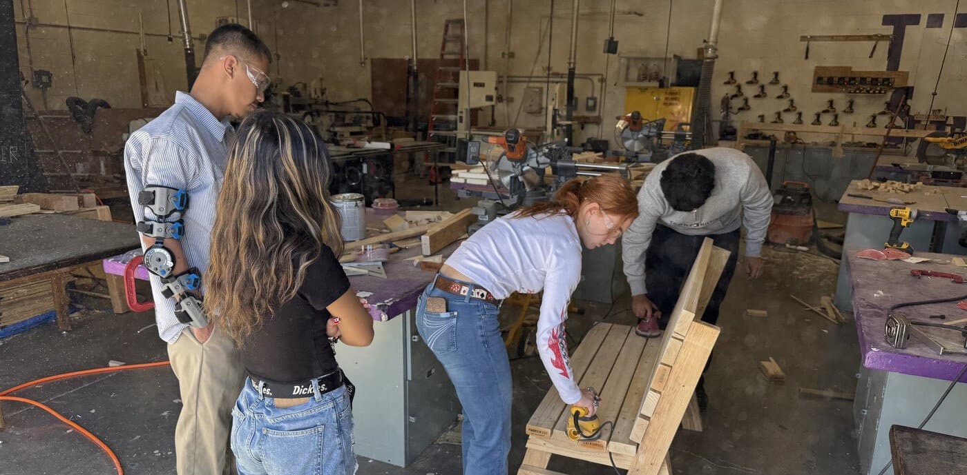 Students working in an EVIT woodshop program; hands-on career-training classrooms are central to the agreement between EVIT and the East Valley districts.