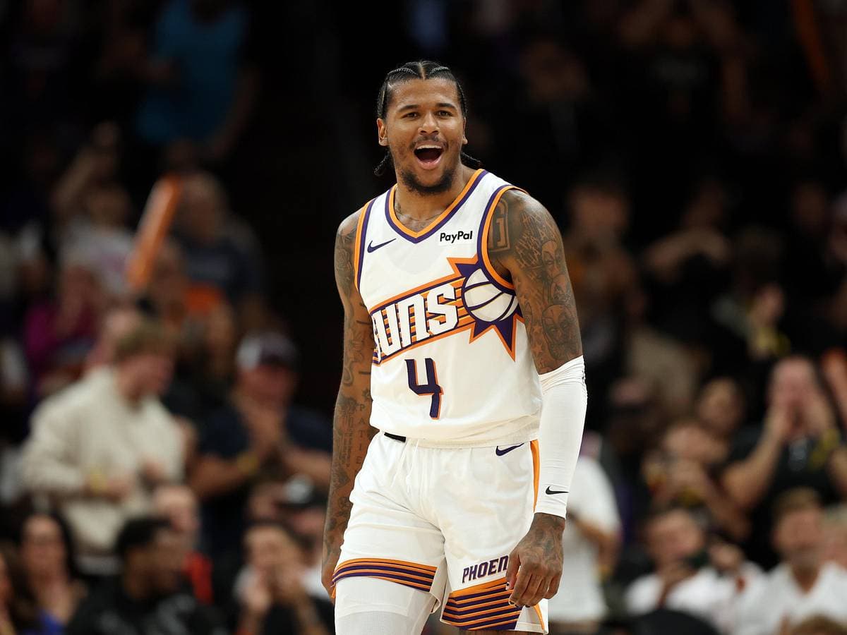 Phoenix Suns guard No. 4 reacts on the court in a game action shot used to illustrate debate over whether the club should move the young guard.