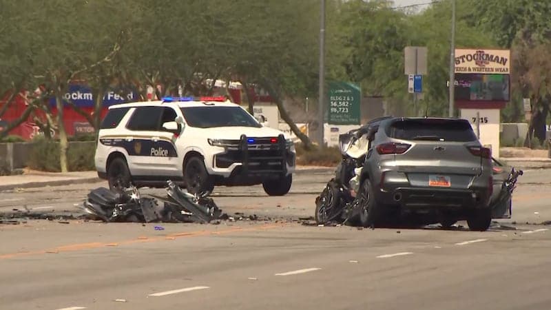Police secure the scene around a heavily damaged SUV and debris in west Phoenix after a multi-vehicle crash that shut down part of I‑10.