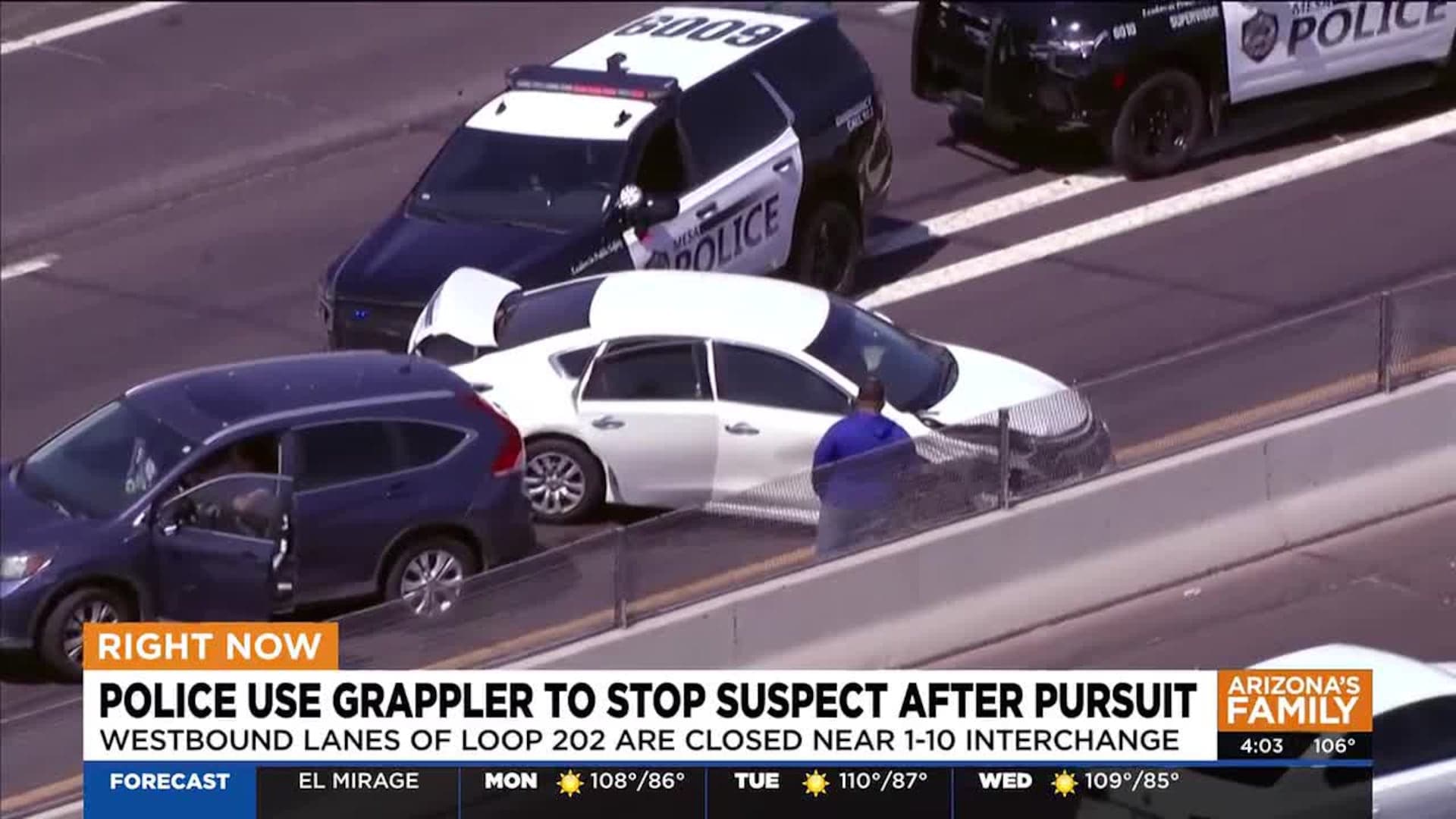 Close-up of a Mesa Police SUV in front of a damaged white sedan, with other stopped vehicles nearby as westbound lanes of Loop 202 were closed during the response.