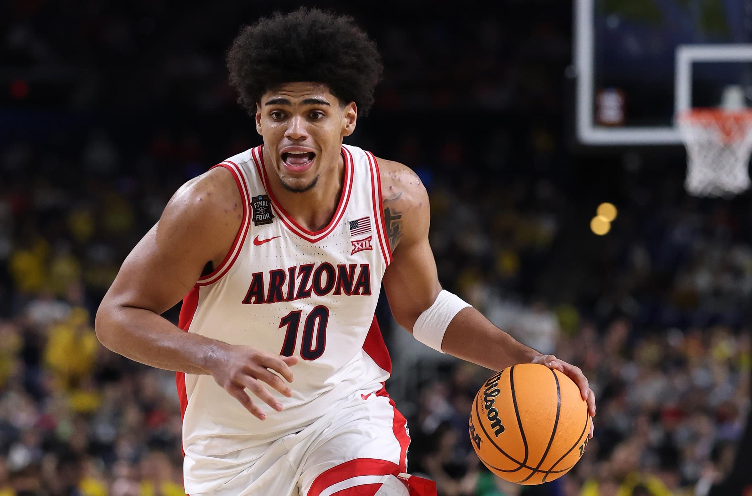 Former Arizona Wildcats guard (No. 10) drives to the basket in a college game — the player was later included in a trade that sent him to the Minnesota Timberwolves.