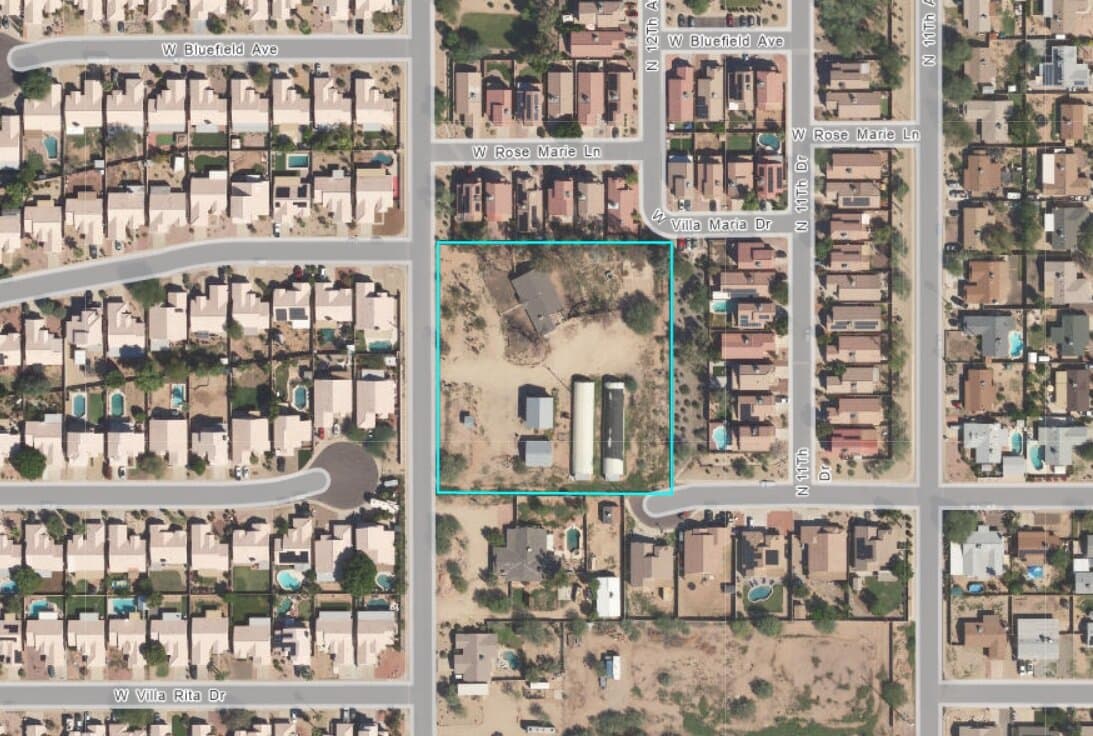 Aerial view showing the vacant parcel outlined in blue where developers propose building the new affordable housing project next to the Acacia Library.