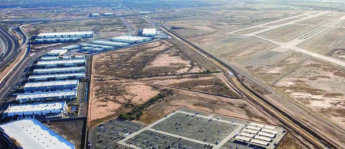 Aerial view of warehouses, vacant industrial lots and runways near Falcon Field/Mesa Gateway — areas Mesa officials are marketing to attract foreign industrial investment.