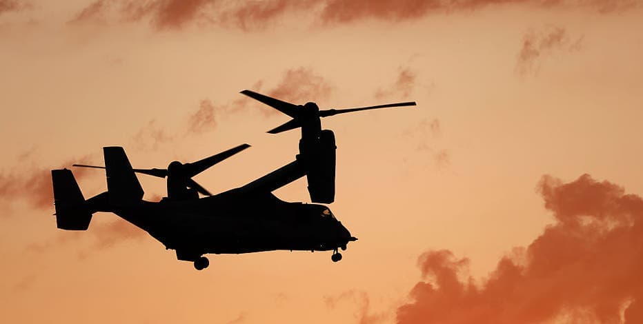 A Bell Boeing V-22 Osprey tiltrotor aircraft silhouetted against a sunset — representative imagery of the Osprey model involved in the fire at Mesa Gateway Airport.