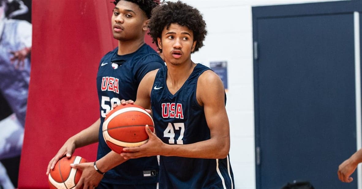 No. 15-ranked guard participating in a USA team workout, holding the ball in a navy USA practice jersey during a national-team session.