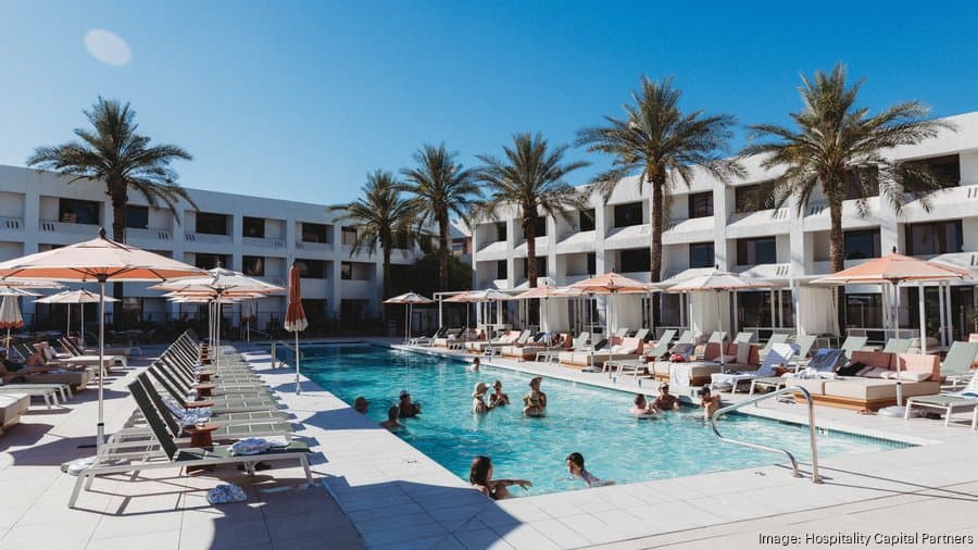 Guests relaxing at the pool deck of a newly opened Hyatt-brand hotel in Arizona, highlighting the leisure amenities at the developer’s latest Valley property.