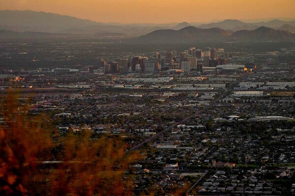 Downtown Phoenix skyline at dusk as the city records a sweltering high — Phoenix hit 115°F at Sky Harbor amid an extreme heat warning.