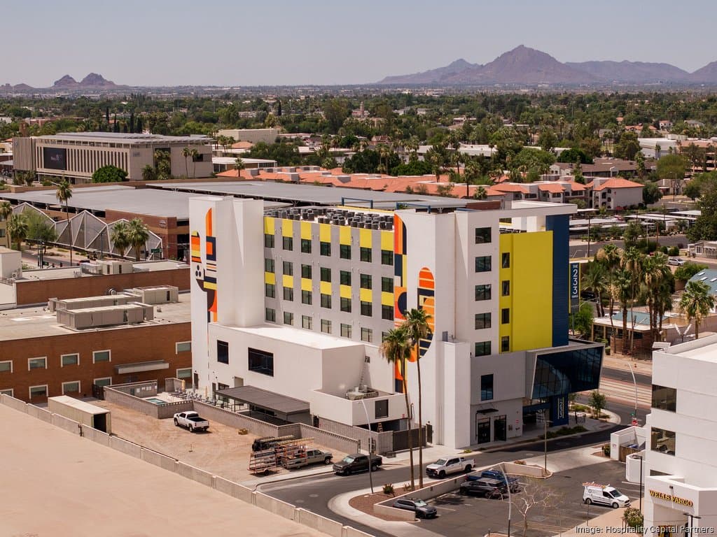 Aerial view of a recently opened Hyatt-brand hotel in the Phoenix area developed by a local firm, showing the property and its surrounding neighborhood.