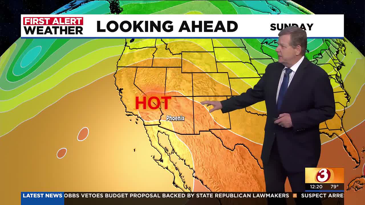 Television weather graphic showing a forecaster gesturing to a large heat map labeled ‘HOT’ centered over Phoenix, illustrating the intense heat expected over the holiday weekend.
