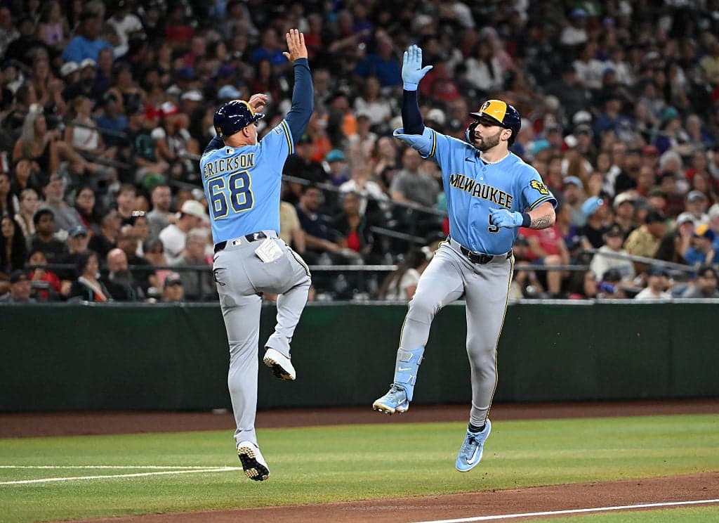 Milwaukee teammates celebrate a run in the late innings as the Brewers mounted a ninth‑inning comeback attempt in Arizona.