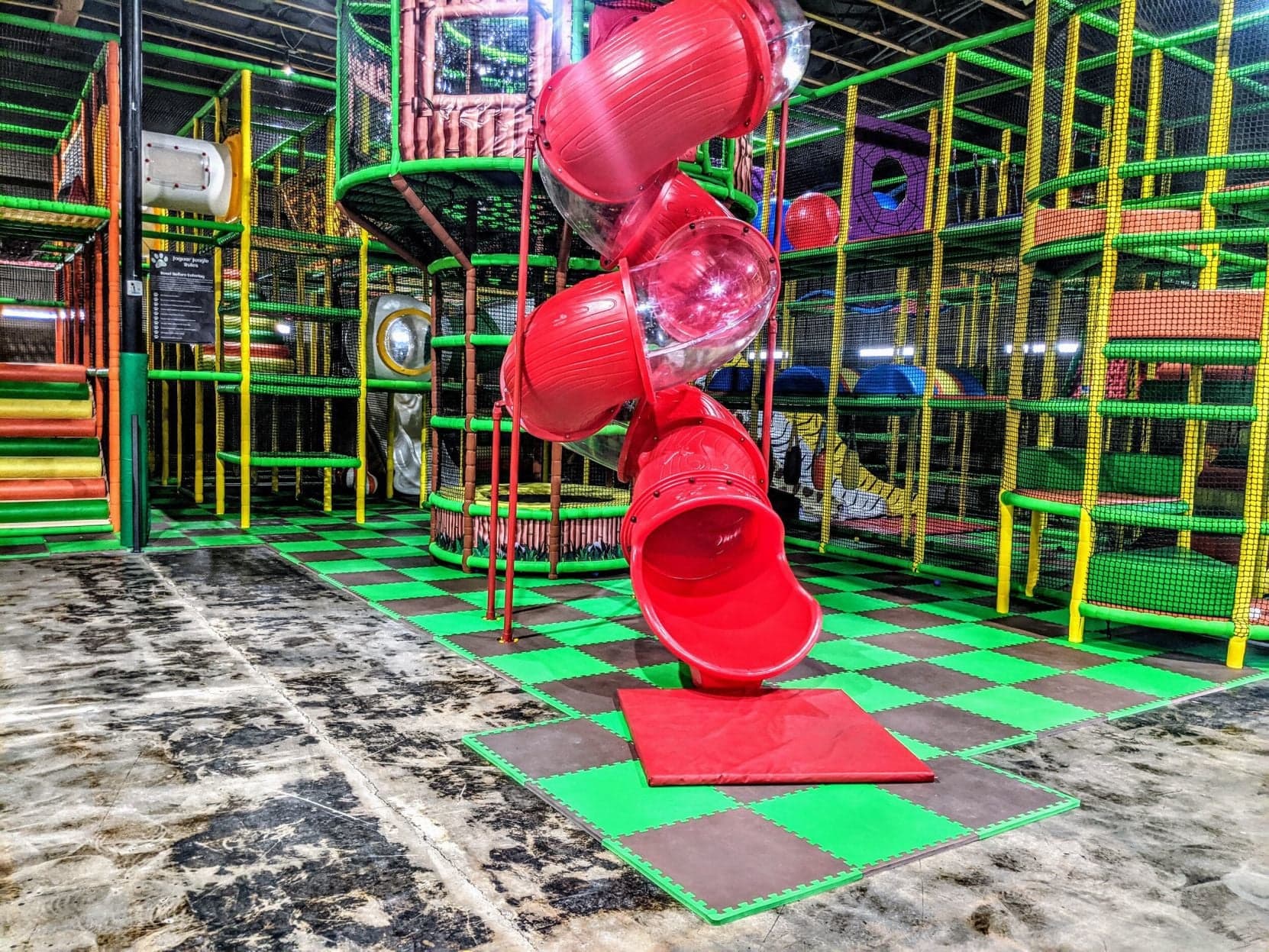 An indoor play structure with a bright red spiral slide — a popular air-conditioned option to keep kids entertained during Tucson’s summer heat.