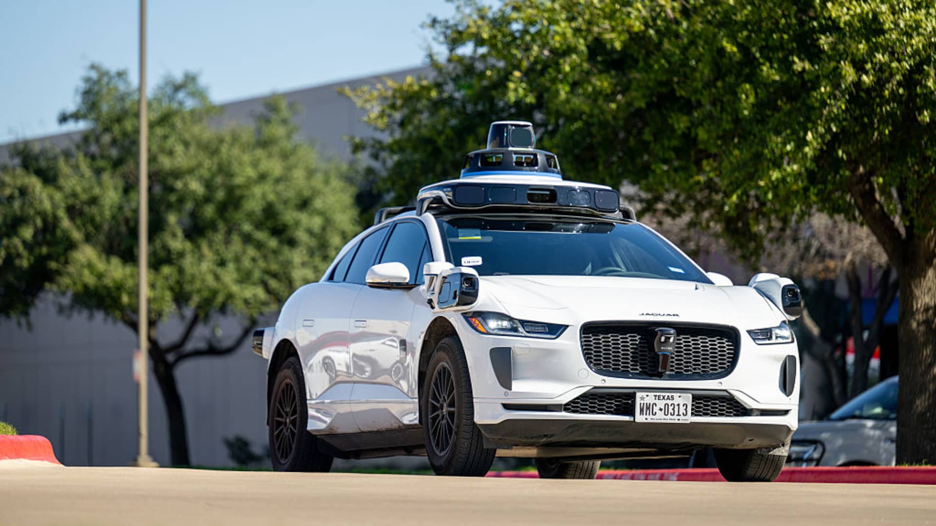 An autonomous vehicle fitted with rooftop sensors, the kind of hardware deployed in robotaxi testing during the Waymo and Uber partnership in Phoenix.