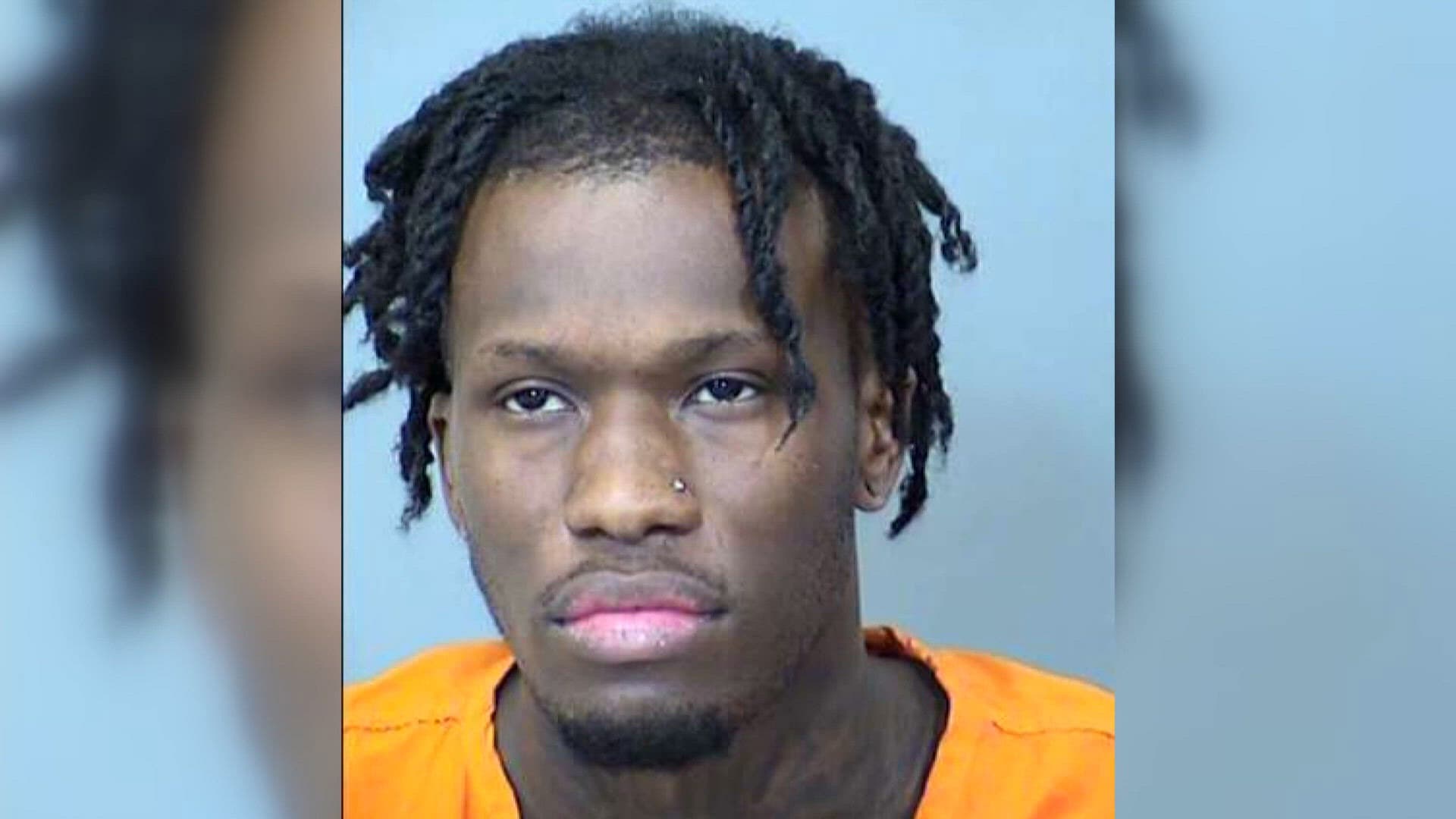 Mugshot of the man accused of shooting a Phoenix police officer eight times, shown in an orange jail jumpsuit as he heads to trial.